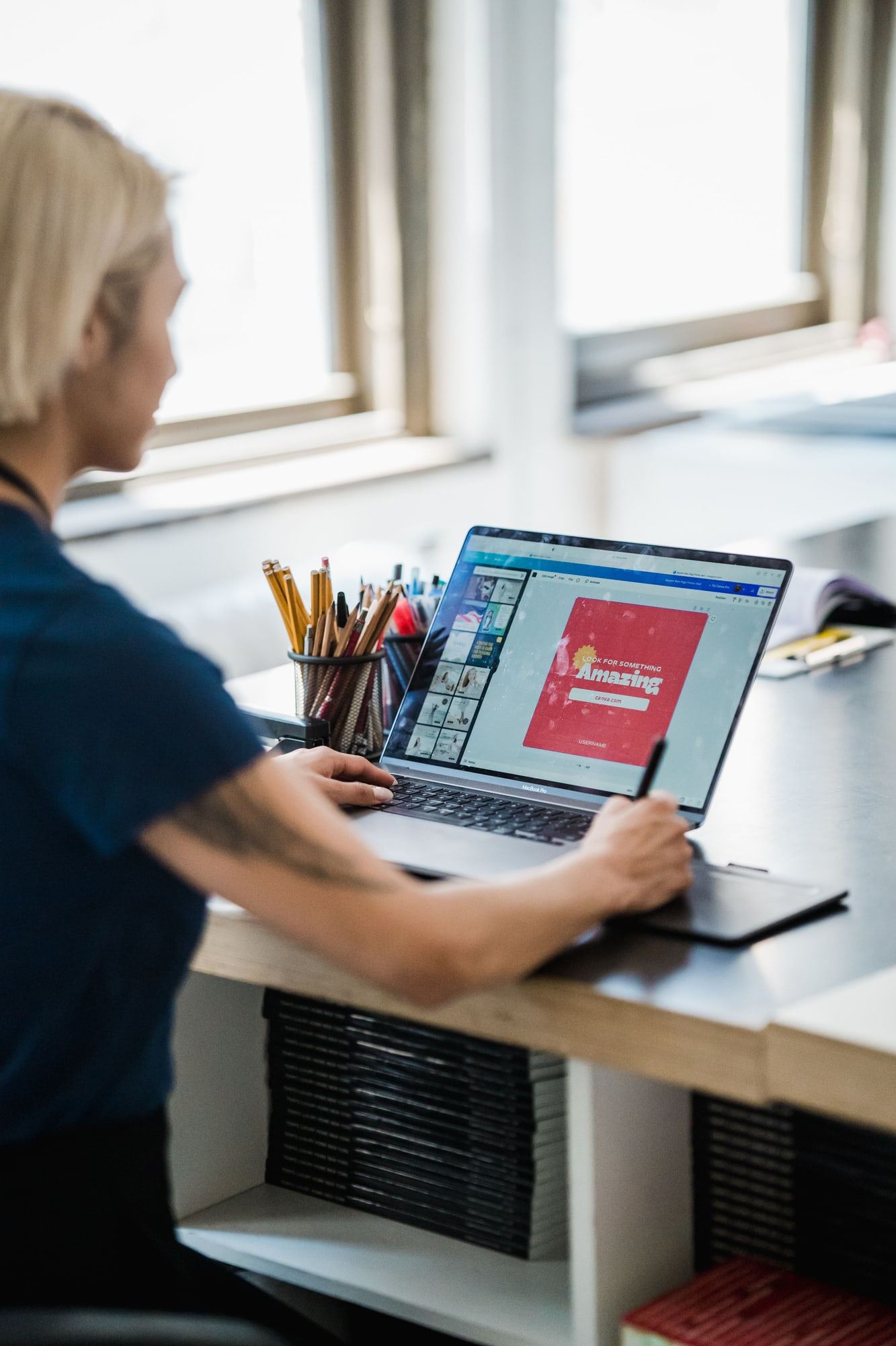 A designer working on display content on a laptop