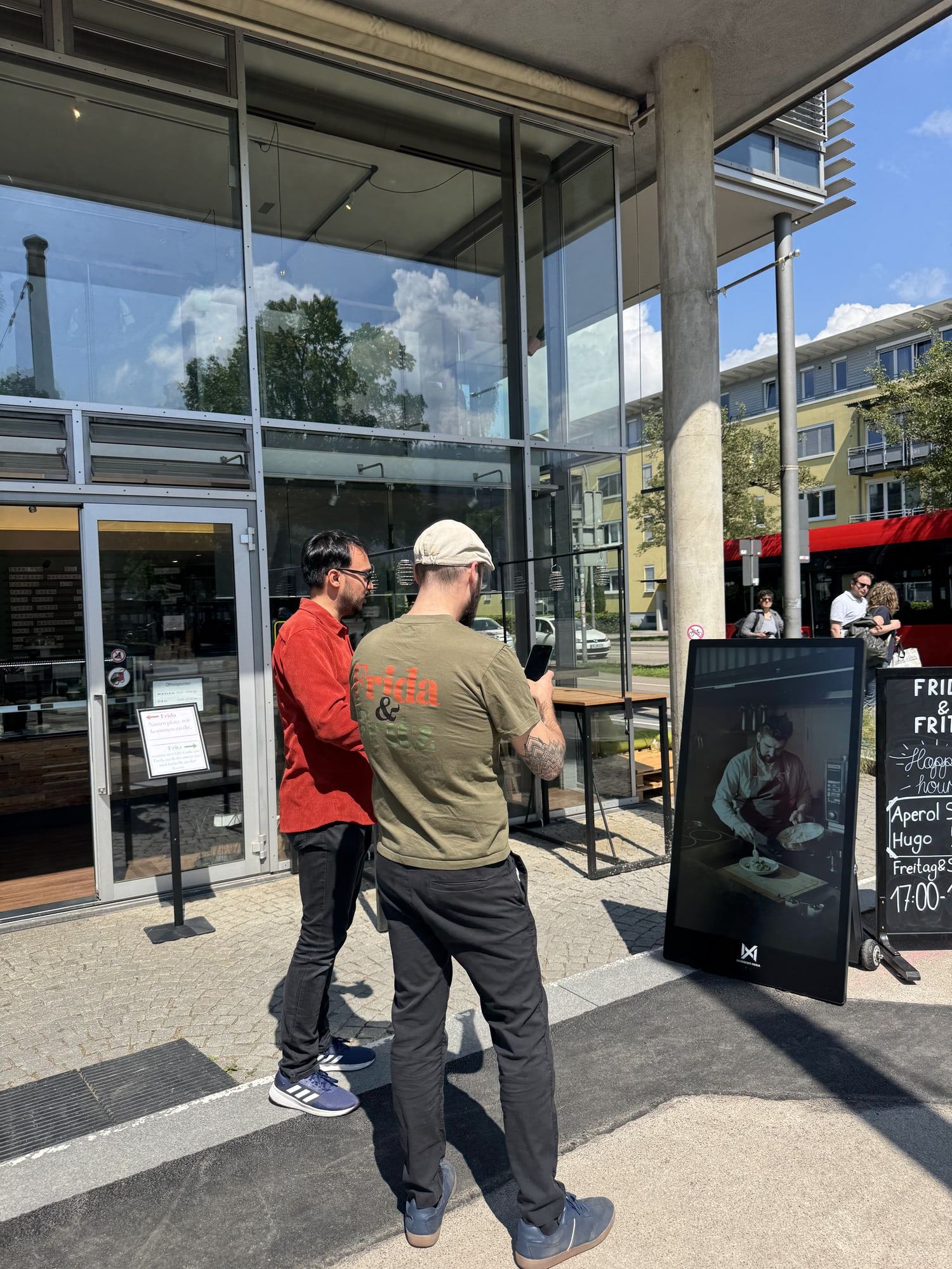 Two people talking next to a Seabiscuit display in front of a store entrance